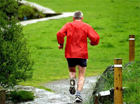 A man jogging in the rain near Llanberis, Snowdonia, North Wales. Stock Photo - Budget Royalty-Free & Subscription, Code: 400-04968857