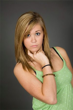 simsearch:400-04960190,k - Teenage girl posing on gray background with some attitude Stock Photo - Budget Royalty-Free & Subscription, Code: 400-04960049