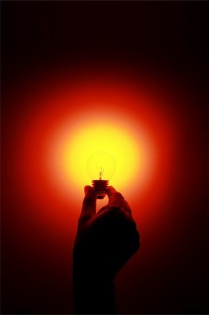 simsearch:640-01354128,k - a hand holding a glowing red light bulb Photographie de stock - Aubaine LD & Abonnement, Code: 400-04961048