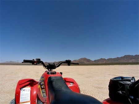 ATV on dry lake bed against mountains and clear blue sky Stock Photo - Budget Royalty-Free & Subscription, Code: 400-04961149