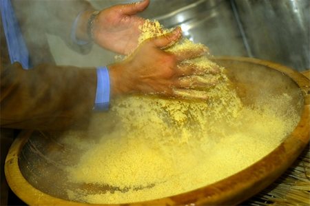 The cook prepares for the Arabian dish Kus-Kus. Hands of the cook in movement Stock Photo - Budget Royalty-Free & Subscription, Code: 400-04961680