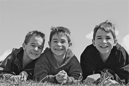 simsearch:400-04449607,k - Three Boys Smiling in Black and White Photographie de stock - Aubaine LD & Abonnement, Code: 400-04961865