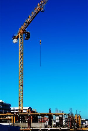 rebañar - A yellow construction crane on a constuction site with the lifting cable hanging in midair Stock Photo - Budget Royalty-Free & Subscription, Code: 400-04962890