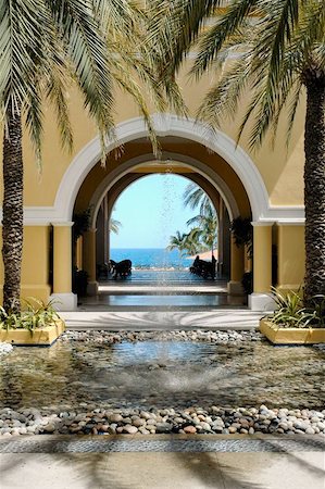 View of ocean through archway, courtyard and fountain in Cabo San Lucas, Mexico Photographie de stock - Aubaine LD & Abonnement, Code: 400-04963347