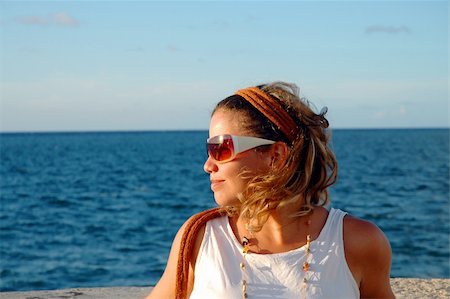 Young girl wearing sunglasses at sunset Stock Photo - Budget Royalty-Free & Subscription, Code: 400-04963342