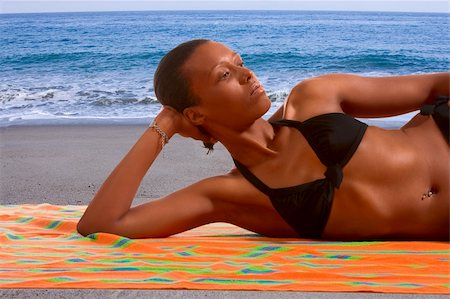 simsearch:614-06169415,k - African-American female relaxing and taking sunbath by sea Photographie de stock - Aubaine LD & Abonnement, Code: 400-04963567