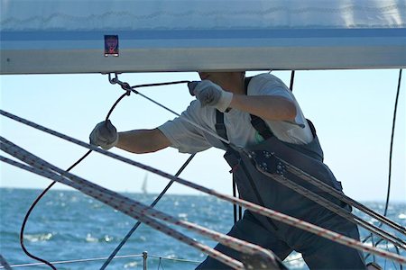 sailboat racing - One the man works with sails and cords. Stock Photo - Budget Royalty-Free & Subscription, Code: 400-04974455