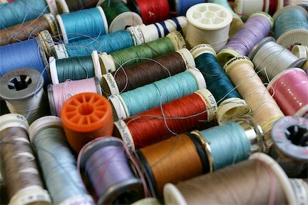 simsearch:400-05267365,k - Colourful background assortment of bobbins and spools of thread. Shallow depth of field - focus in the middle. Stock Photo - Budget Royalty-Free & Subscription, Code: 400-04974904