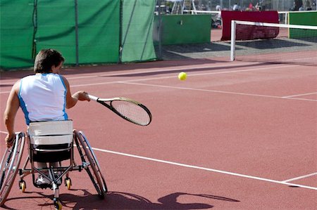 simsearch:400-08755898,k - A wheelchair tennis player during a tennis championship match, taking a shot. Stock Photo - Budget Royalty-Free & Subscription, Code: 400-04975736