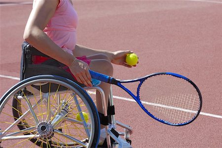 paraplegic women in wheelchairs - Detail of a wheelchair tennis player about to serve during a tennis championship match. Space for text on the plain area of the court behind her. Stock Photo - Budget Royalty-Free & Subscription, Code: 400-04975737