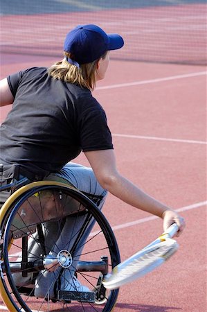 simsearch:400-08755898,k - A wheelchair tennis player during a tennis championship match, returning a shot. Motion blur on her racket. Stock Photo - Budget Royalty-Free & Subscription, Code: 400-04975738