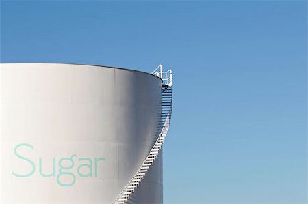 refined sugar - sugar silo with stairs and giant "sugar" lettering, white silo against clear blue sky with copyspace Stock Photo - Budget Royalty-Free & Subscription, Code: 400-04976674