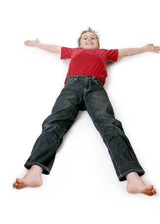 A boy lies outstretched on a floor. Stock Photo - Budget Royalty-Free & Subscription, Code: 400-04976684