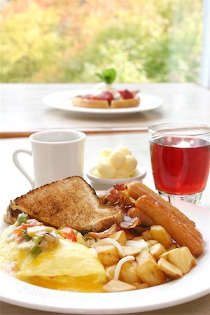 A power packed breakfast of omelette, sausages and bacon, accompanied by hash browns and toast. Served with choice of coffee or cranberry juice. Stock Photo - Budget Royalty-Free & Subscription, Code: 400-04976883