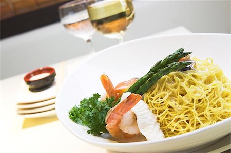 Delicious seafood fried noodles with shrimps, fish, squid and mushroom. Served with asparagus. Stock Photo - Budget Royalty-Free & Subscription, Code: 400-04976903