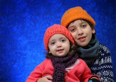 sister hugs baby - Brother and sister hugging in winter outfit. Look at my gallery for more winter images Stock Photo - Budget Royalty-Free & Subscription, Code: 400-04978734