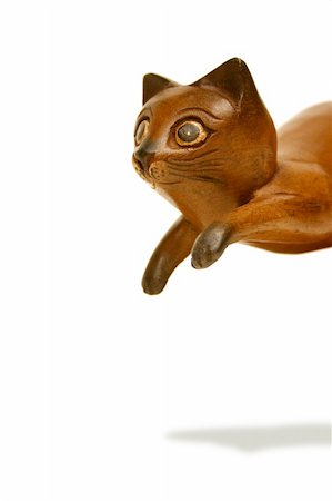 Wooden cat statue caught in a playful pounce. Clipping path included. Stock Photo - Budget Royalty-Free & Subscription, Code: 400-04978763