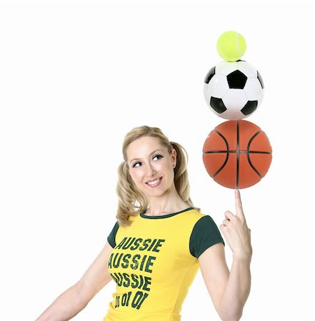 Cheerful, Aussie girl in green and gold balancing sporting balls. Stock Photo - Budget Royalty-Free & Subscription, Code: 400-04978983