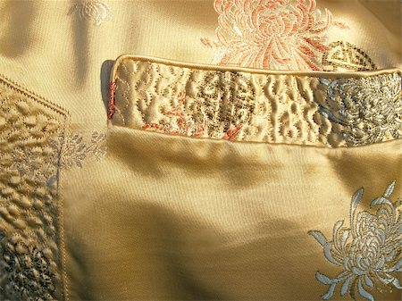 Detail  of Chinese gold silk jacket; pocket and side slit close-up.  (with Chrysanthemum pattern) Stock Photo - Budget Royalty-Free & Subscription, Code: 400-04979012