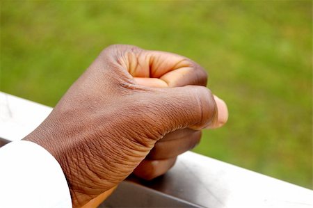 This is an image of a fist "stamped" against a metal surface. The posture of the hand can represent authority and judgement/decisiveness, while as the metal surface can represent hardness, toughness etc... Stock Photo - Budget Royalty-Free & Subscription, Code: 400-04979330