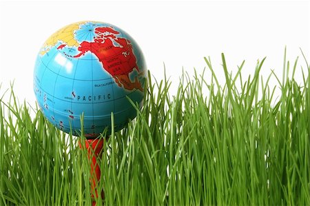 Green grass on white with golf tee and globe instead of golf ball Stock Photo - Budget Royalty-Free & Subscription, Code: 400-04979497