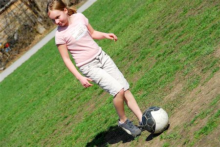 Young girl playing soccer in school yard Stock Photo - Budget Royalty-Free & Subscription, Code: 400-04970599