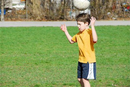 Little boy bouncing soccer ball on his head Stock Photo - Budget Royalty-Free & Subscription, Code: 400-04970601