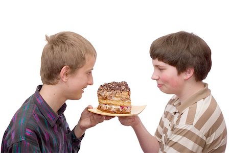 Two boys champing to eat a large piece of home-made cake Stock Photo - Budget Royalty-Free & Subscription, Code: 400-04971591