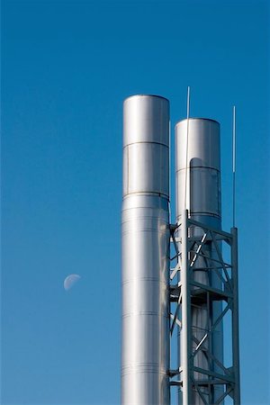 Two metal chimneys against the blue sky with the moon Stock Photo - Budget Royalty-Free & Subscription, Code: 400-04972557