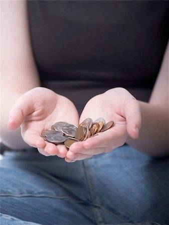 color photo of a girl holding coins in her hands Stock Photo - Budget Royalty-Free & Subscription, Code: 400-04973224