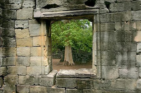 picture on wall of angkor temple - A tree outside a window of an ancient stone wall (Angkor temples) in Siem Reap, Cambodia. Stock Photo - Budget Royalty-Free & Subscription, Code: 400-04973597