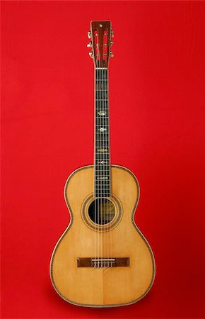 simsearch:400-07505739,k - Guitar over red background. Beautiful musical instrument Stock Photo - Budget Royalty-Free & Subscription, Code: 400-04973891