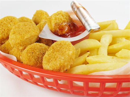 Basket of chicken nuggets with french fries and sweet and sour sauce. Stock Photo - Budget Royalty-Free & Subscription, Code: 400-04984579