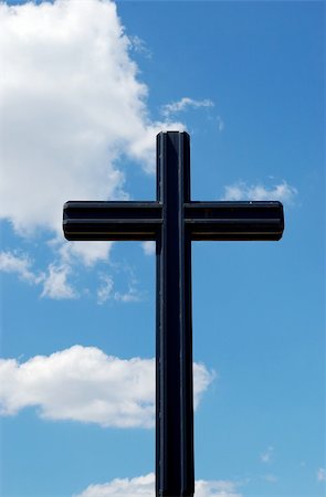 black metal cross on a cloudy blue sky background Stock Photo - Budget Royalty-Free & Subscription, Code: 400-04985270