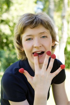 raspberry fingers - woman with raspberries, shot outdoors Stock Photo - Budget Royalty-Free & Subscription, Code: 400-04985506