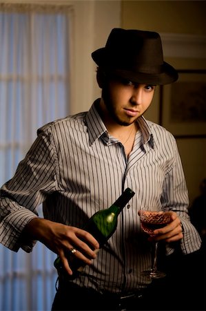 port wine - Handsome Young Man Indoors Wearing a Fedora Hat and Red Wine Stock Photo - Budget Royalty-Free & Subscription, Code: 400-04985573