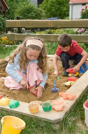 sandbox - boy and girl playing in sand box Stock Photo - Budget Royalty-Free & Subscription, Code: 400-04986602