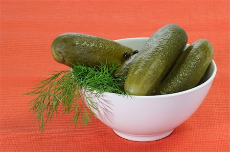 pickling gherkin - Pickled cucumbers in a bowl on red background Stock Photo - Budget Royalty-Free & Subscription, Code: 400-04986788