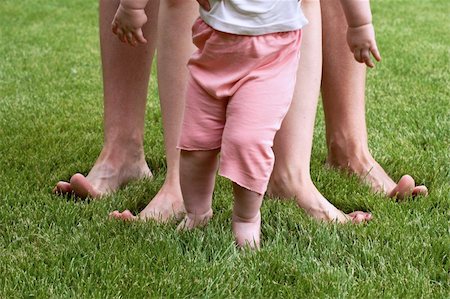 feet in the meadow - tot learns to go on herb with parents Stock Photo - Budget Royalty-Free & Subscription, Code: 400-04986917