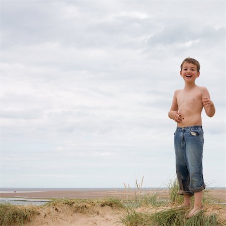 who needs the sun, when you have mud (very dirty young boy at seaside, overcast day) Stock Photo - Budget Royalty-Free & Subscription, Code: 400-04987078