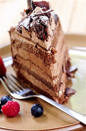 decorating a chocolate frosted cake - Slice of chocolate mousse cake served on a plate Stock Photo - Budget Royalty-Free & Subscription, Code: 400-04987400