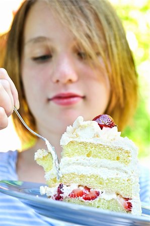 eating cake at cafe - Teenage girl eating a piece of strawberry cake Stock Photo - Budget Royalty-Free & Subscription, Code: 400-04987402