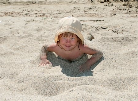 The baby girl plays with a sand Stock Photo - Budget Royalty-Free & Subscription, Code: 400-04987778