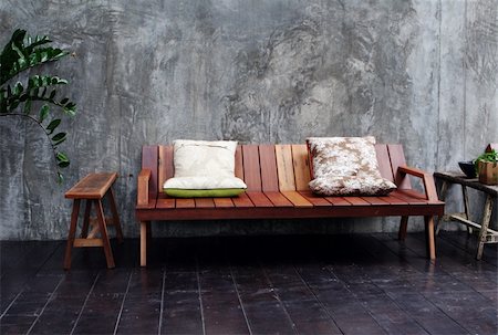 simsearch:400-03961189,k - Wooden sofa and cushions in a modern interior. Fotografie stock - Microstock e Abbonamento, Codice: 400-04989205