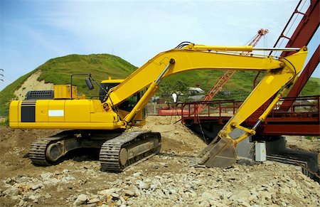 The Big caterpillar excavator of the yellow  colour after functioning Stock Photo - Budget Royalty-Free & Subscription, Code: 400-04989309