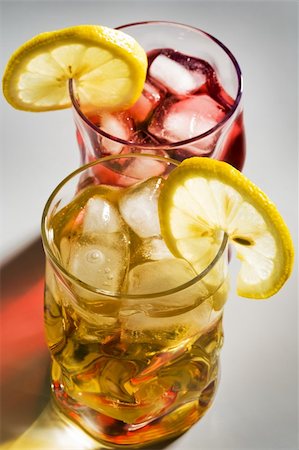 simsearch:400-03979160,k - Beautiful glasses with a cocktail, a lemon and an ice Stock Photo - Budget Royalty-Free & Subscription, Code: 400-04989396