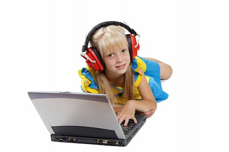 simsearch:400-05717354,k - The girl with headphones lays before a portable computer on a white background Stock Photo - Budget Royalty-Free & Subscription, Code: 400-04989414
