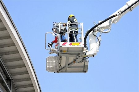 firefighters spray water - Fire fighter in big and tall crane Stock Photo - Budget Royalty-Free & Subscription, Code: 400-04989425