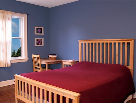 Beautifully decorated red and blue bedroom with Mission style furniture.  Photographs on walls were taken by the same photographer, so copyright is not an issue. Stock Photo - Budget Royalty-Free & Subscription, Code: 400-04980976