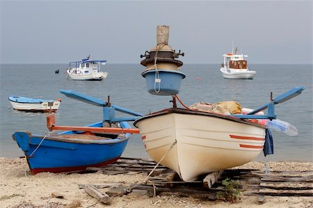 dinghy - greek fishing boats anchored off the beach Stock Photo - Budget Royalty-Free & Subscription, Code: 400-04981425